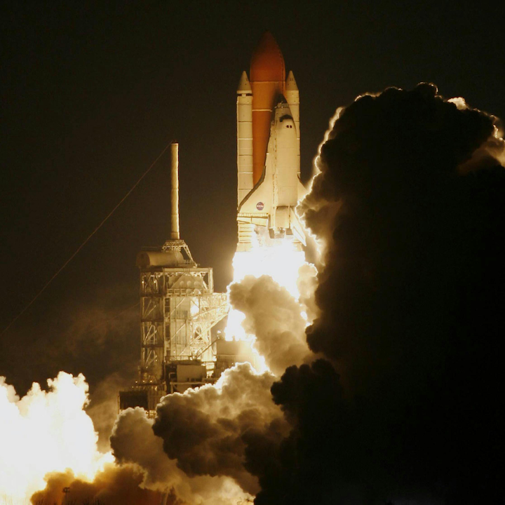 A space shuttle taking off at night